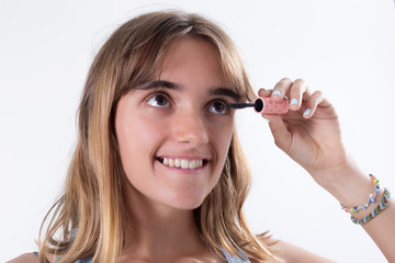 Young teenager doing eyelash makeup