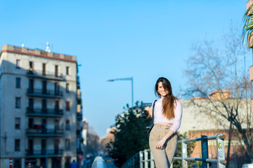 young beautiful woman in casual wear walking outdoors in the city