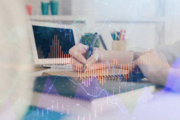 Financial graph displayed on woman's hand taking notes background. Concept of research. Double exposure