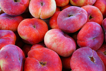 Fresh donut flat peaches at a French farmers market