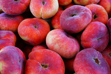 Fresh donut flat peaches at a French farmers market