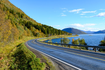 Scenic asphalt road through the beautiful view of mountain in lofoten island, Norway during autumn. Concept of roadtrip, travel, vacation, adventure