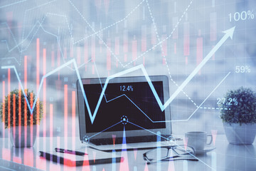 Forex graph hologram on table with computer background. Multi exposure. Concept of financial markets.