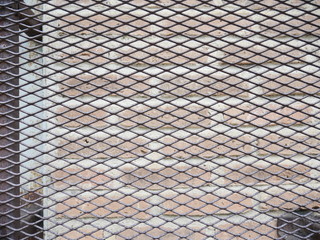 the cage metal net on  brick background