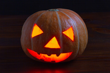 Jack lantern glowing pumpkin for Halloween on dark background