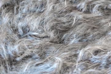 Fragment of a down scarf made of wool close-up. Texture of downy knitted thing