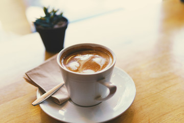 cup of coffee on wooden table