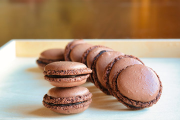 group of homemade chocolate macarons on a tray