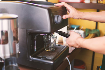 barista pouring coffee in machine