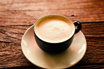 cup of coffee on wooden table