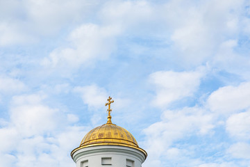 Aureate church cupola in front of sky