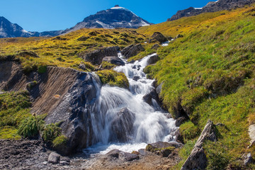Fototapeta na wymiar picturesque landscape with rapid mountain stream in the Swiss Alps