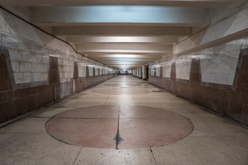 Old empty underpass with granite and marble walls