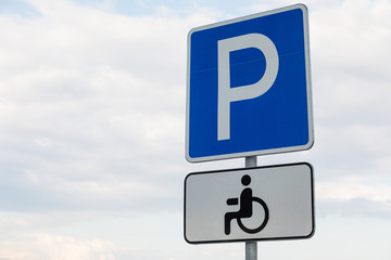 Roadsign Parking lot with white tablet for handicapped