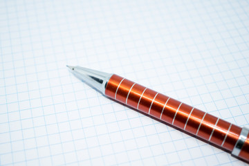 Photo of an automatic red pencil on a light background.