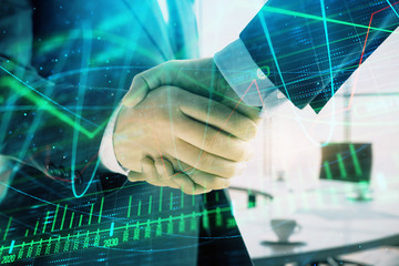 Fototapeta na wymiar Multi exposure of financial graph on office background with two businessmen handshake. Concept of success in business