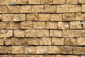 Uneven and carelessly cladded with yellow decorative tile wall