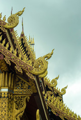 Fototapeta na wymiar Ornate eaves and roof decorations of Wat Saen Muang Ma Luang, Chiang Mai, Thailand