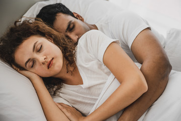 Obraz na płótnie Canvas a man and a woman lying on a bed