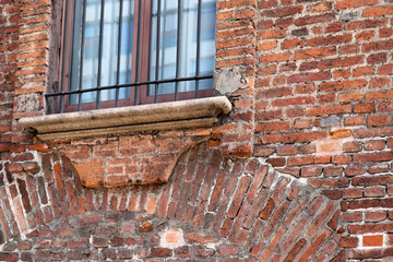 Faded window on brick wall facade