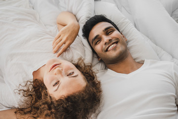 a man and a woman lying on a bed