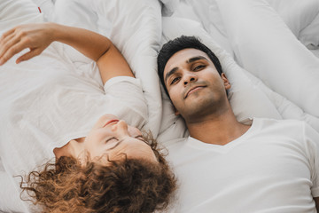 a man and a woman lying on a bed
