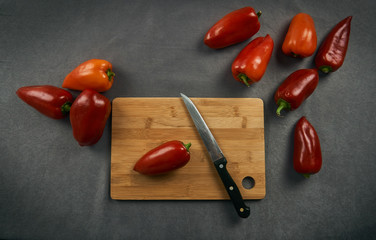knife on a cutting board and juicy bell pepper