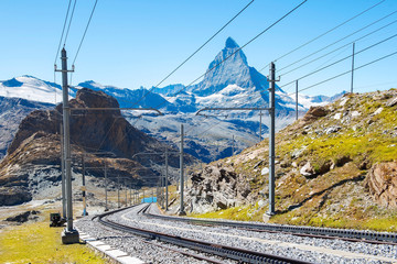 Fototapeta na wymiar magnificent landscape in the Swiss Alps, in the foreground a railway, in the background a mountain Matterhorn