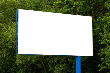 Close-up white blank billboard against green forest along road
