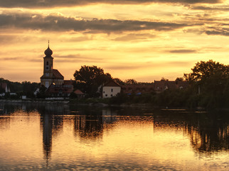 Fototapeta premium Village with church on sunset