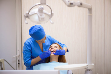 Dentist examining a patient's teeth in the dentist.