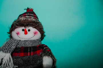 Fototapeta premium Beautiful christmas snowman with a green backdrop. Toy background