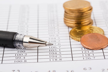 Finance Concept. Financial reports, euro coins, US coin  on business chart.