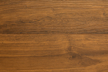 Close-up of dark chestnut laminate floor covering