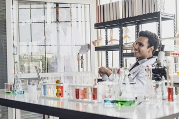 Team of Medical Research Scientist Conducts Experiments in Laboratory with Microscope, Test Tubes, Micropipette and other equipment.