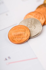 Finance Concept. Financial reports, euro coins, US coin  on business chart.