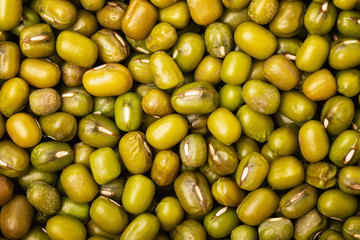 Macro flatlay image of green mung beans as healthy food background.