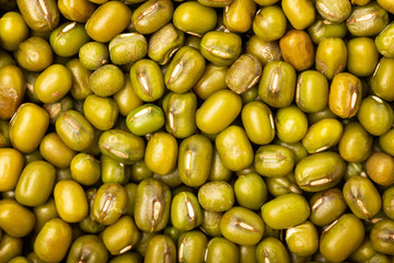 Macro flatlay image of green mung beans as healthy food background.