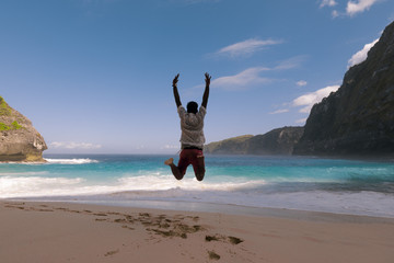 Tourist jumps on a beach in bali