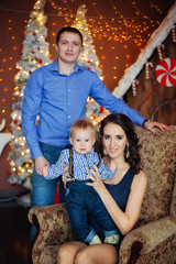 happy family of three in a chair for Christmas