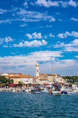 Fototapeta na wymiar Panoramic view of Krk town with blue Adriatic Sea and boats on sunny summer day, Krk Island in Croatia