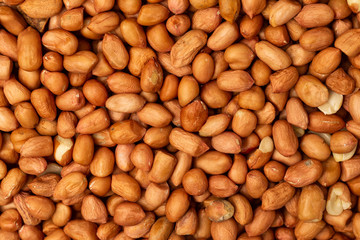 Closeup flatlay image of salted peanuts as a food background.