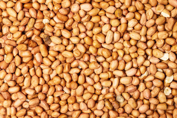 Closeup flatlay image of salted peanuts as a food background.
