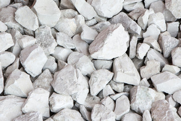 Small decorative limestone stones of light beige tone, background