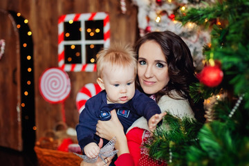 Fototapeta na wymiar mother and child decorating christmas tree