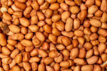 Macro flatlay image of roasted peanuts as a natural food pattern.