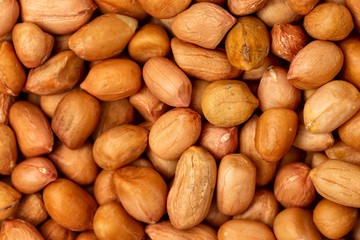 Macro top view image of roasted peanuts as a food background.