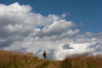 A wonderful walk along the ridge in the Ukrainian Carpathians amidst the scent of flowers, the dramatic cloudy sky before the rain with a thunderstorm.