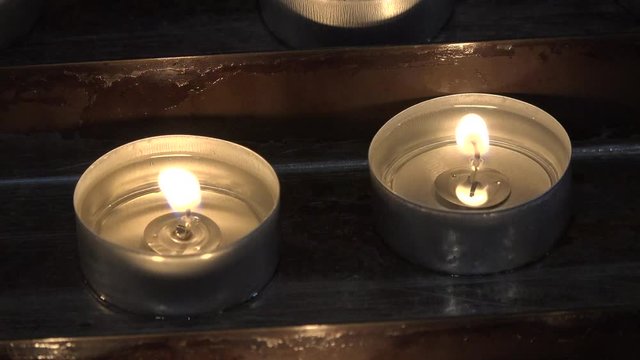 Candles are lit in lamps in the Orthodox Church.