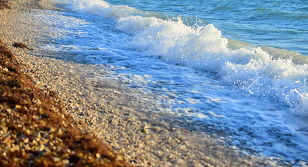 Soft wave of blue ocean on beach.